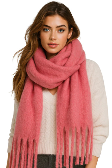 Woman wearing an oversized pink blanket scarf on a white background